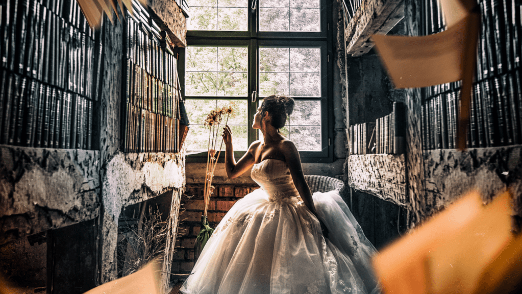 Woman in white dress in a library of old books